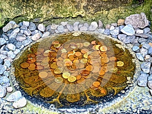 Money in a well at Clonmacnoise Monastery, County Offaly, Ireland photo