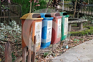 Clorful trash cans lined up in the park