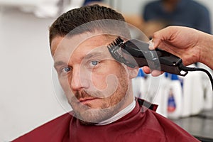 Male client getting haircut by hairdresser. photo