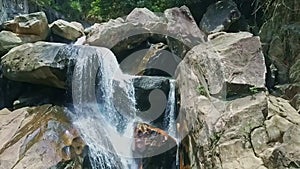 Close Aerial View Fantastic Foamy Waterfall on Large Rocks