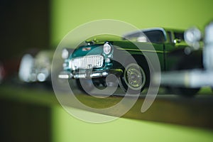 A close attention to the details. Retro styled cars. Toy cars with retro design. Retro car models on shelf. Classic