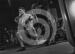 A close black-and-white photograph, a bodybuilder athlete, train