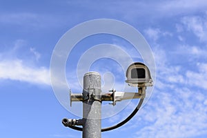 The close circuit camera on the pole with the blue sky