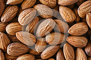 Close detail of a pile of raw almonds nuts with peel