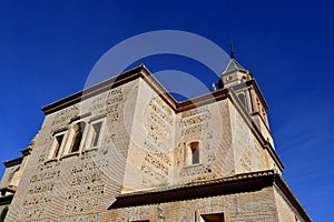 Close detailed view from below of Charles V Palace under a blue sky.  Alhambra, Granada, Spain