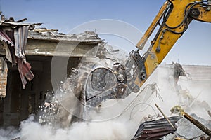 Close of excavator arm demolishing