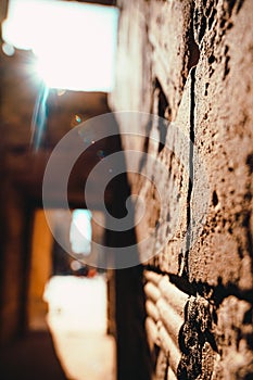 Close focus on a wall in a temple in egypt, ancient stone walls and pillars. Harsh sun shining straight into the lens