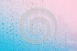 Close focus on water drop on colorful glass