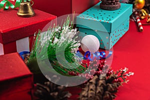 Close frame for New Year and Christmas decorations, gift wrapping, ribbons, pine cones on a red background