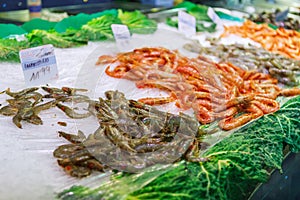 Close fresh raw shrimps on display on ice on fishermen market store shop