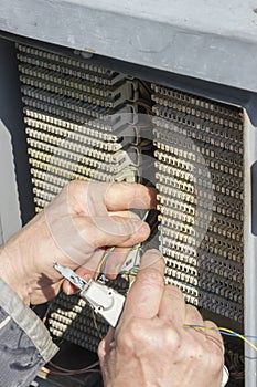 Close of hands punching down circuit panel