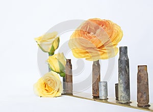 Close Image Ranunculus and Roses in Rusted Bullet Shell Vases