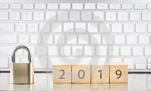 Close key lock with year number 2019, keyboard background