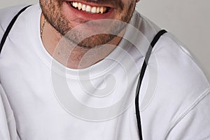 Close male smile with healthy beautiful flat teeth. Isolated on white background. No face. Text space. Dentist concept