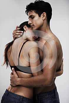 So close our souls are connected. Studio shot of a young couple sharing an intimate moment against a gray background.