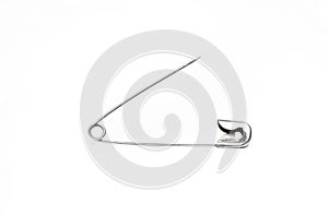 Close p opened safety pin on white background