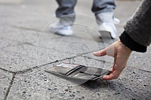 Person Picking Up A Lost Wallet photo