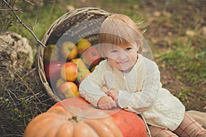 Close portrait baby girl with blond red hair wearing ivory colour white sweater enjoy life time city village with basket ped crib