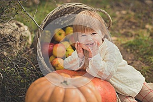 Close portrait baby girl with blond red hair wearing ivory colour white sweater enjoy life time city village with basket ped crib