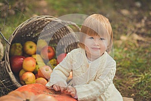 Close portrait baby girl with blond red hair wearing ivory colour white sweater enjoy life time city village with basket ped crib