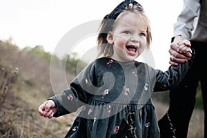 Close portrait of Cute little smiling girl is wallking in autumn forest.