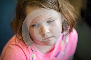 Close Portrait of Girl Thinking Sitting Down