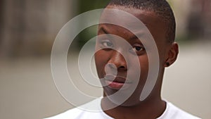 Close portrait of a handsome young african american man. Emotions of people, the guy is perplexed, shows discontent and
