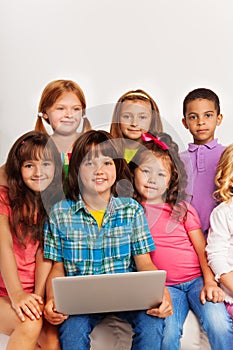 Close portrait of kids with laptop