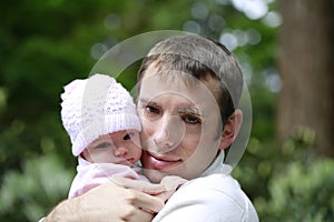 Close portrait of a loving father hugging little daughter