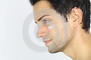 Close portrait of a man with moisturizer on her face