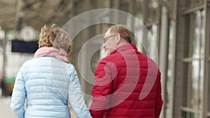 Close portrait of a mature couple in love. A man and a woman hug and leave, holding hands. Late love, happy family