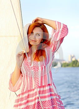 Close portrait of a stunning red-haired girl looking at the camera
