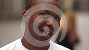 Close portrait of a surprised african american guy in good mood. Emotions of people, white-toothed smile, rally against