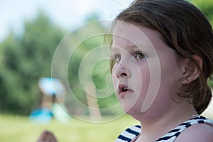Close Portrait of Young Girl Looking Concerned Outside