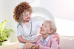 Close positive relationship between senior patient and caregiver. Happy senior woman talking to a friendly caregiver. Young pretty