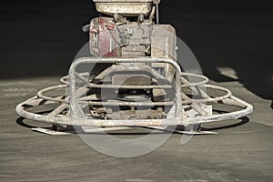 Close of power trowel on fresh concrete