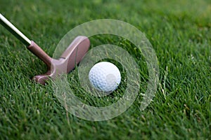 Close of putter and ball