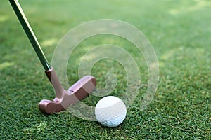 Close of putter and ball