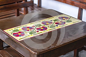 Close shoot of wooden table with flower ornamentation