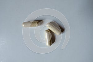 Close shot of 3 beige capsules of Saccharomyces boulardii probiotic