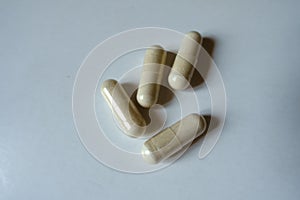 Close shot of 4 beige capsules of Saccharomyces boulardii probiotic