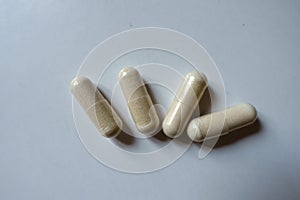 Close shot of 4 beige capsules of Saccharomyces boulardii probiotic