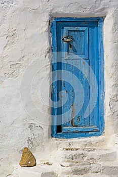 Close shot of blue door on a white house in Mykonos