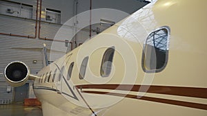 Close Shot of a Brand New Airplane board Standing in a Aircraft Hangar