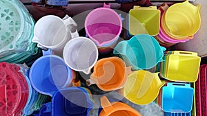 Close shot of collection of mugs,household articles buckets mugs multicolored in supermarket