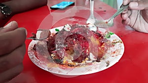 A Close Shot Of Dry Fruit Ice Gola Or Ice Gola On Ceramic Plate. Indian dessert Gola is made up of crushed ice cream and dry