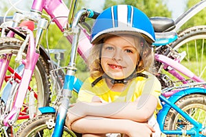 Close shot of a girl in blue bicycle helmet