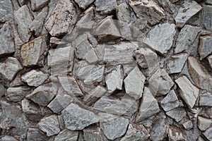 Close shot of gray gravel pebble dash on the wall