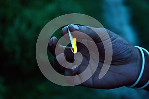 Close shot of a hand holding match stick lighting in between the palm. Manâ€™s hand protecting the lightening of the match stick