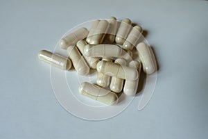 Close shot of heap of beige capsules of Saccharomyces boulardii probiotic